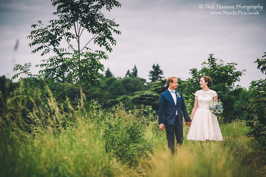 Bride and Groom walking in the countryside at Herons Farm
