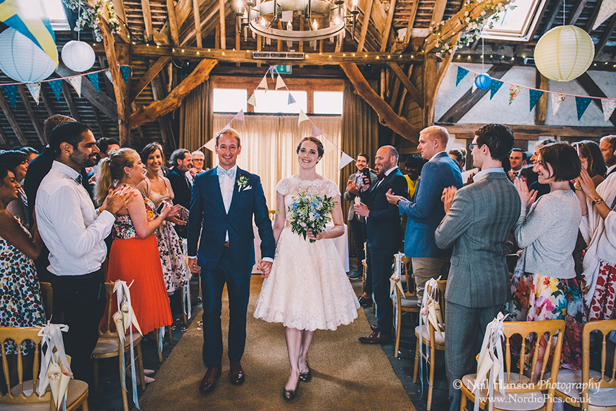 Bride and groom exit their wedding ceremony at Herons Farm