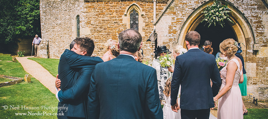 Wedding guests congratulating the Bride and Groom outside Rousham Church
