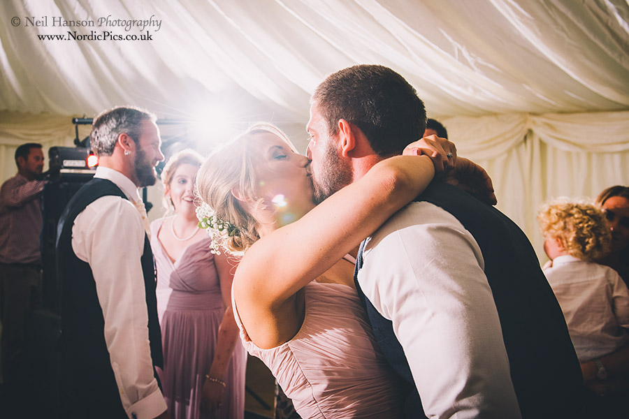 Wedding guests kissing on the dance floor