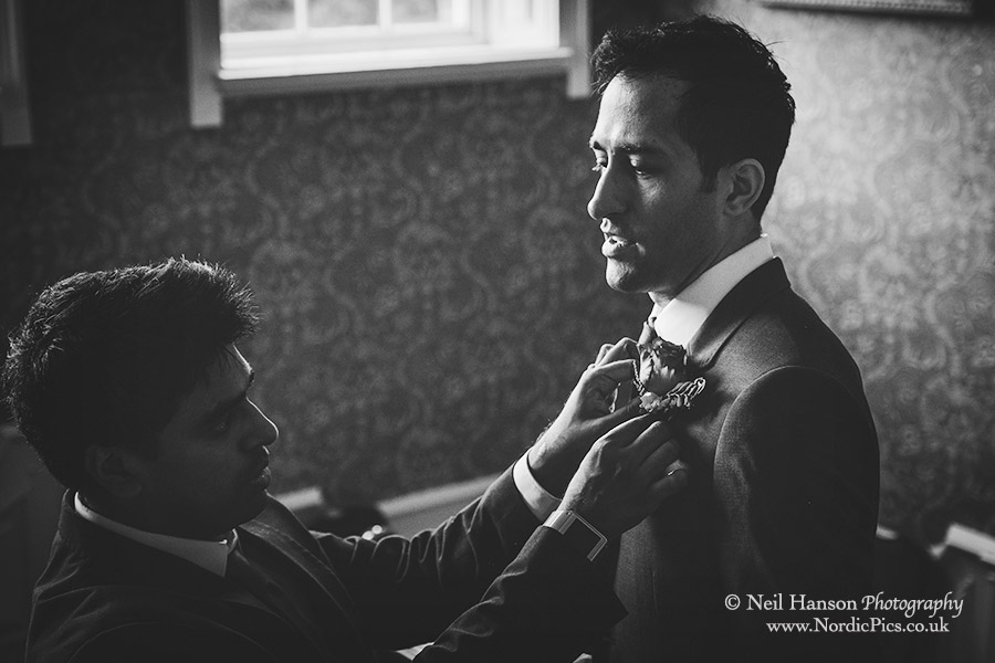Groom having his button hole flower put on