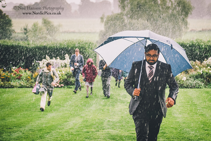 Wedding guests running in the rain