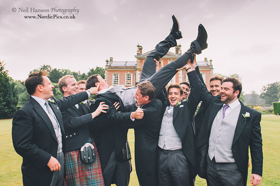 Groom being lifted into the air