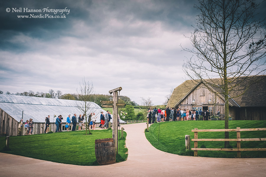 Wedding guests moving from the Hay barn to the Barwell Barn for the wedding reception