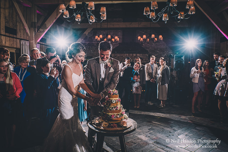 Bride and Groom cutting their cake at Soho farmhouse Wedding