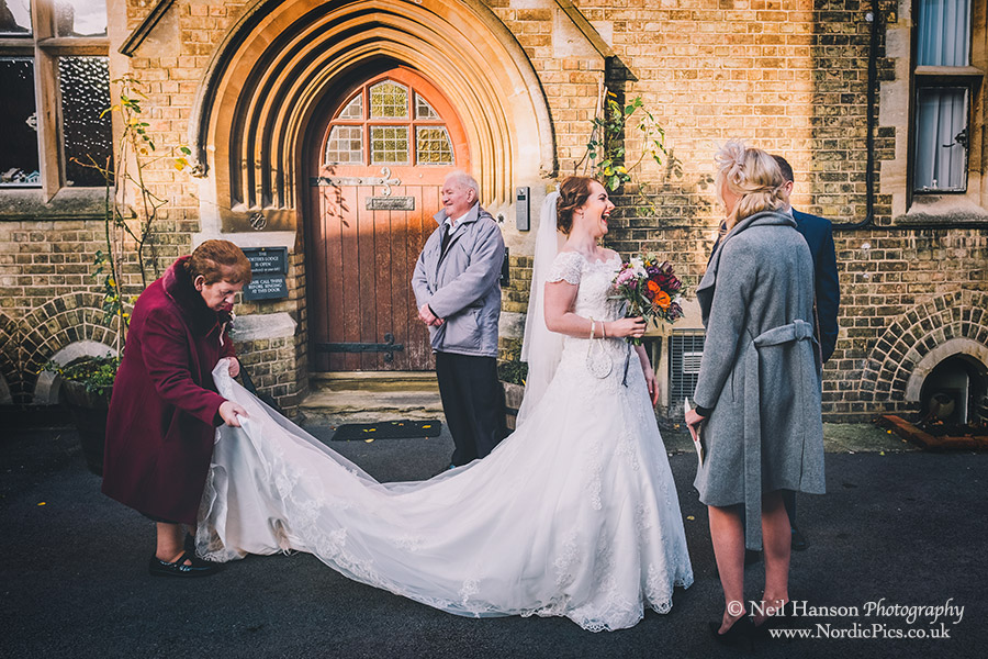 Grandparents attend to the brides wedding dress