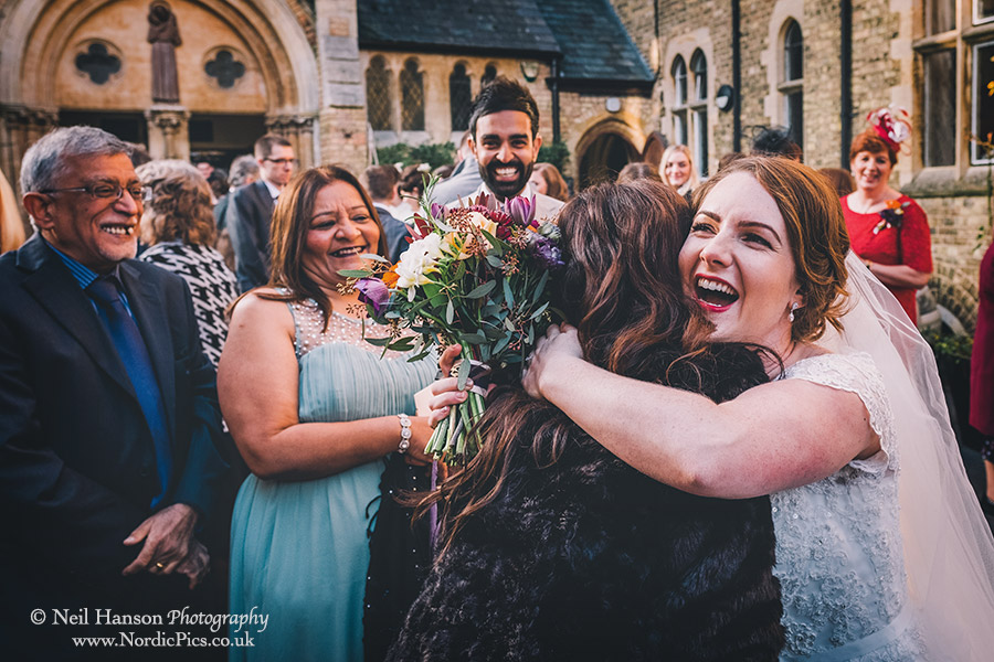 Friends greeting the bride after her wedding at The Oxford Oratory