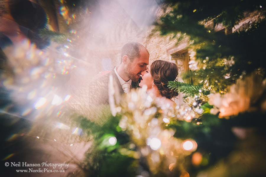 Creative Bride and Groom portrait by the Christmas Tree
