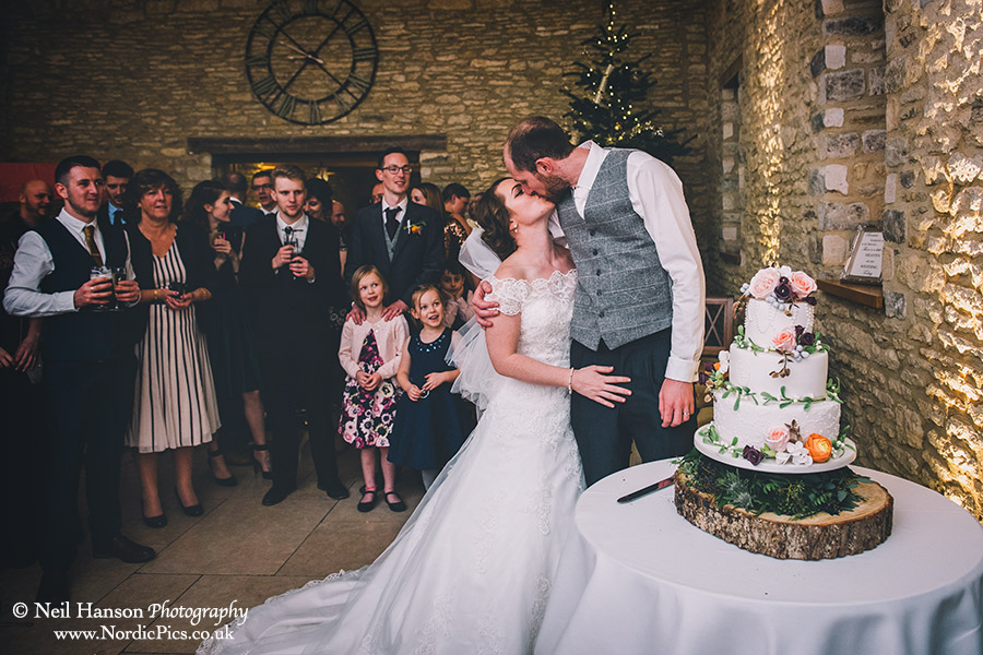 Bride and Groom cutting the cake at a Winter Wedding at Caswell House