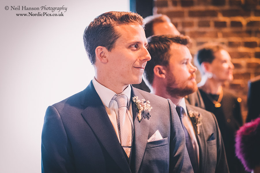 Groom awaits his bride at Cooling Castle Barn Wedding