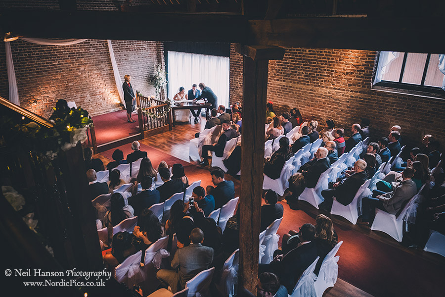 Signing the register at a Cooling Castle Barn Wedding
