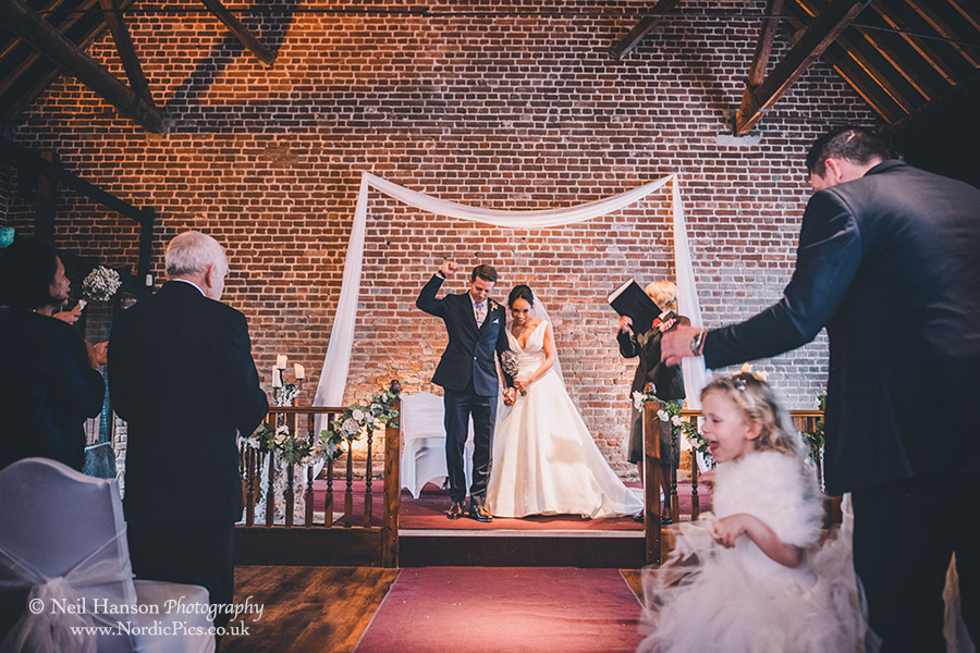 Bride & Groom exit their wedding ceremony at Cooling Castle Barn