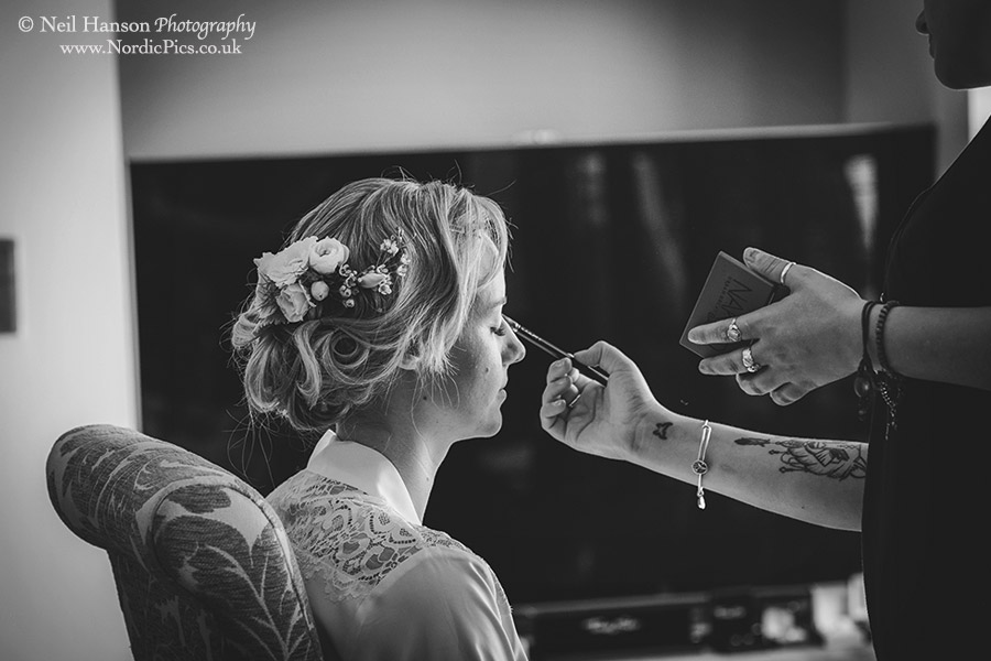 Bride having her make-up applied in the morning