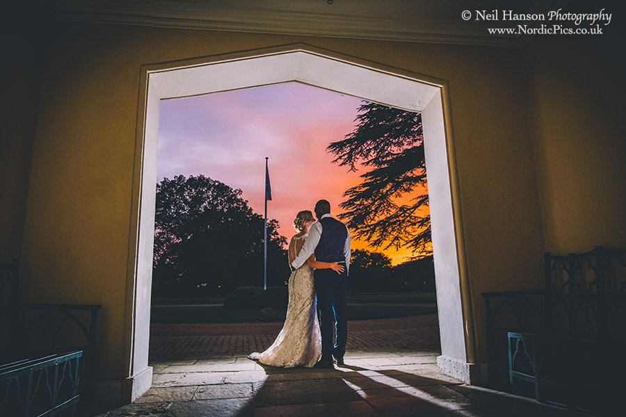 Bride and Groom watching the sun set on their Wedding day at Hampden House