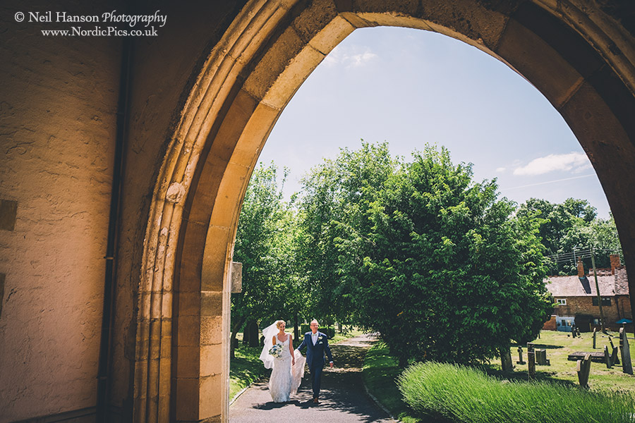 Bride and her father walking up to the entrance of Waddesdon Church