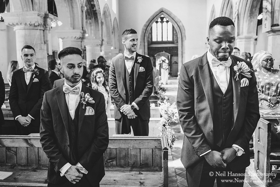 The groom waiting at the alter for his bride to enter