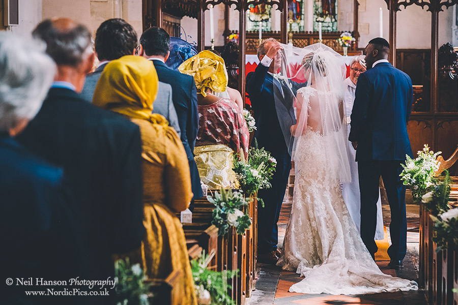 Father lifts his daughters veil open her wedding day at Waddesdon Church