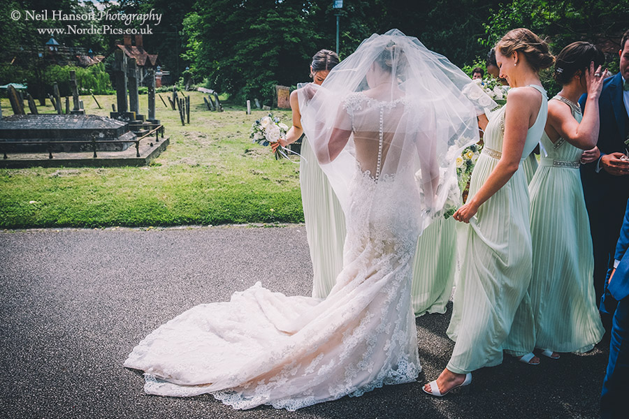 Bride adjusts her veil in the wind