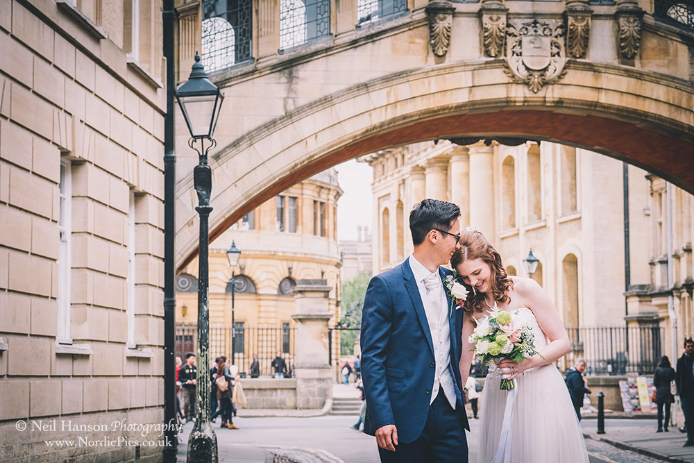 Bride and groom under the bridge of Sighs in Oxford