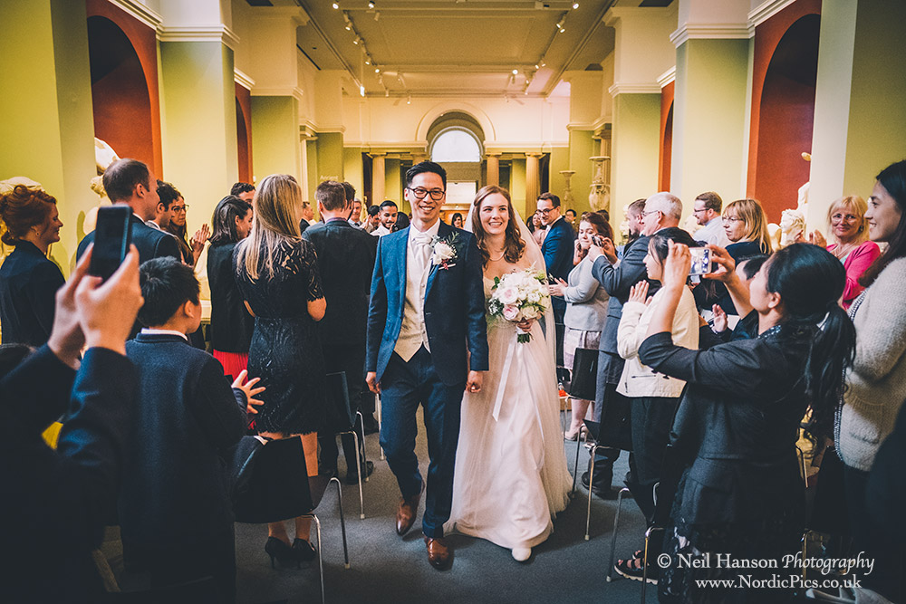 Bride and Groom exit their wedding ceremony at the Ashmolean Museum Oxford