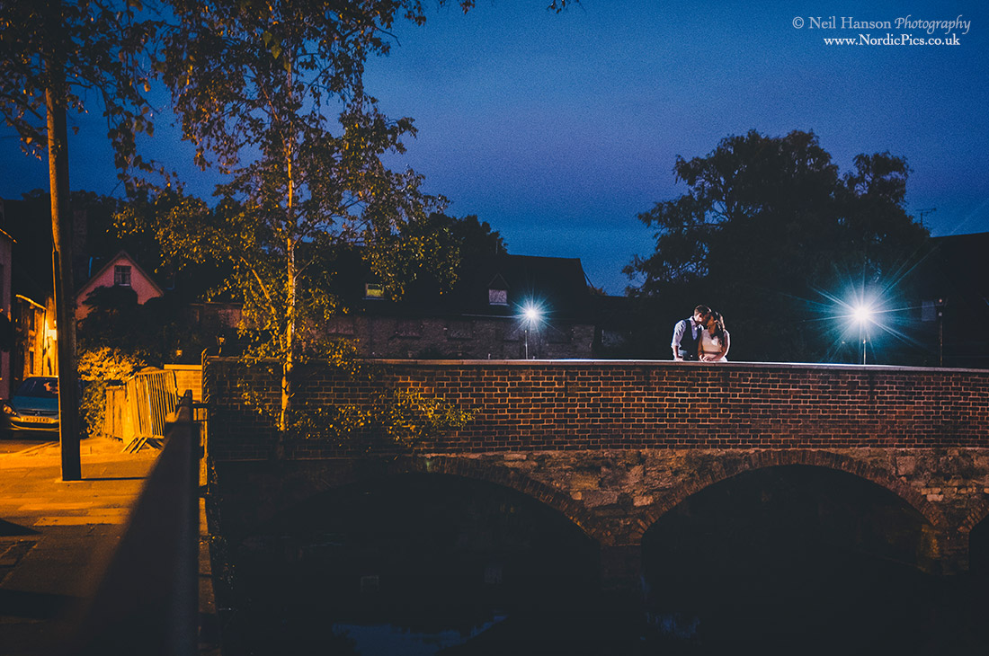 Bride and Groom on a bridge in Abingdon at night
