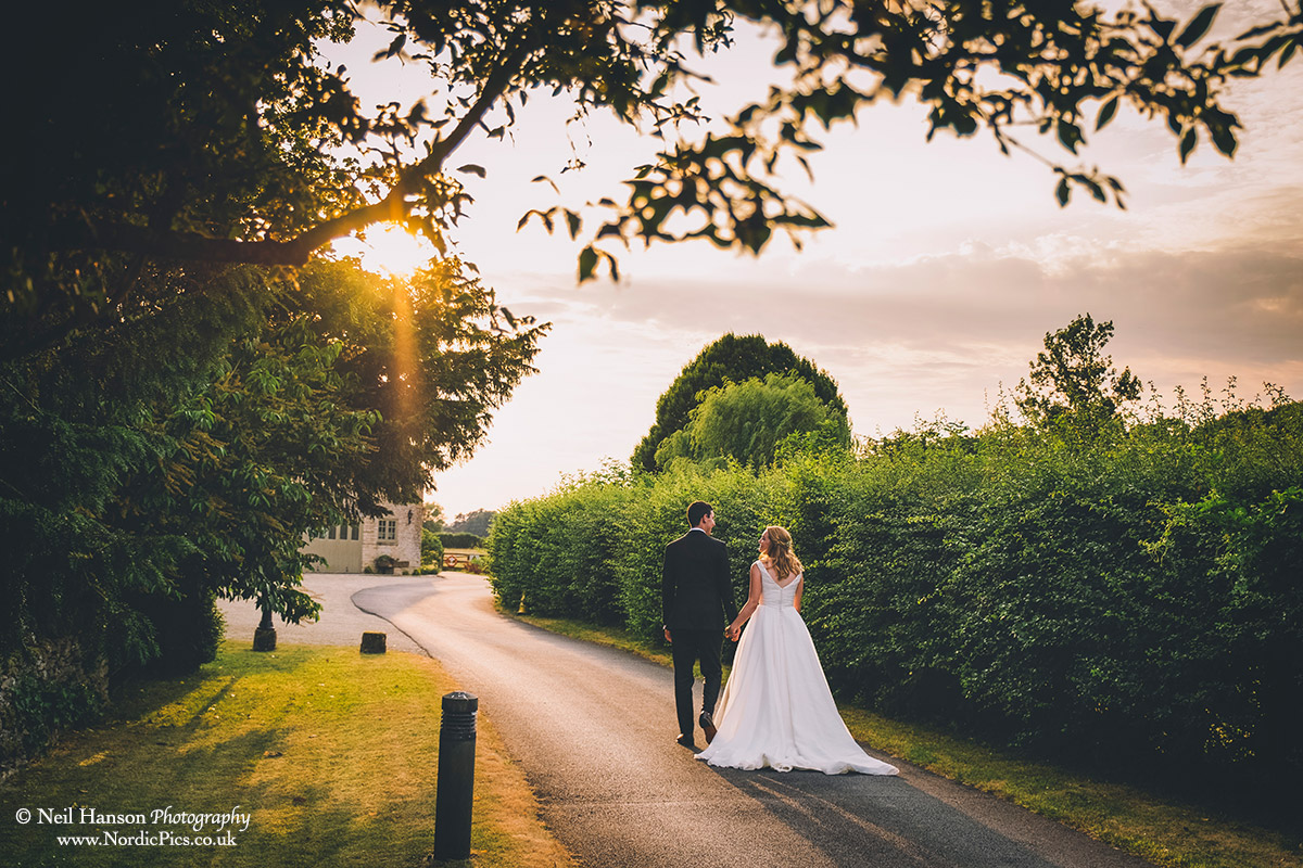 Bride and Groom walking into the sunset at a Caswell House Wedding