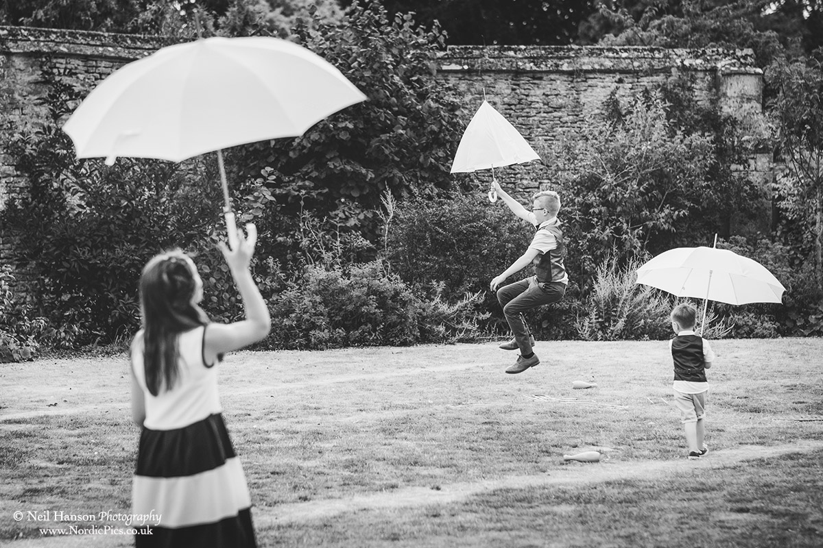 Children with umbrellas at a Caswell house Wedding