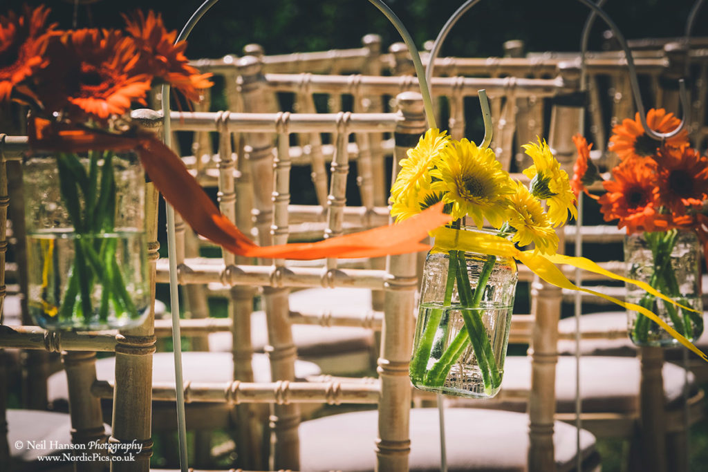 Flowers on each chair ends for an outdoor wedding ceremony