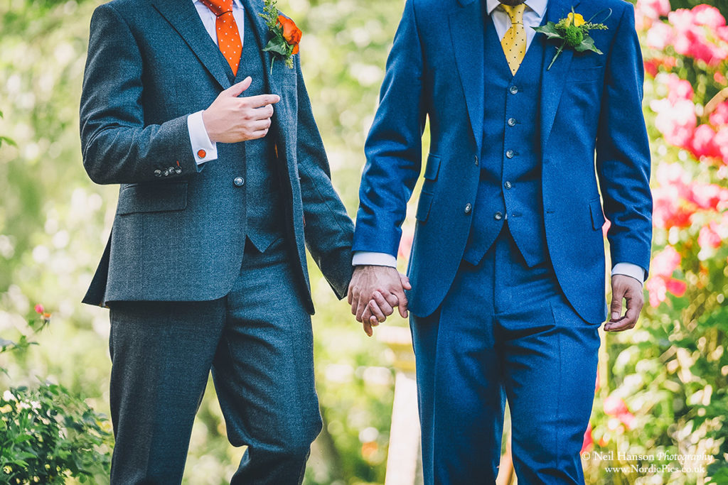 Grooms holding hands