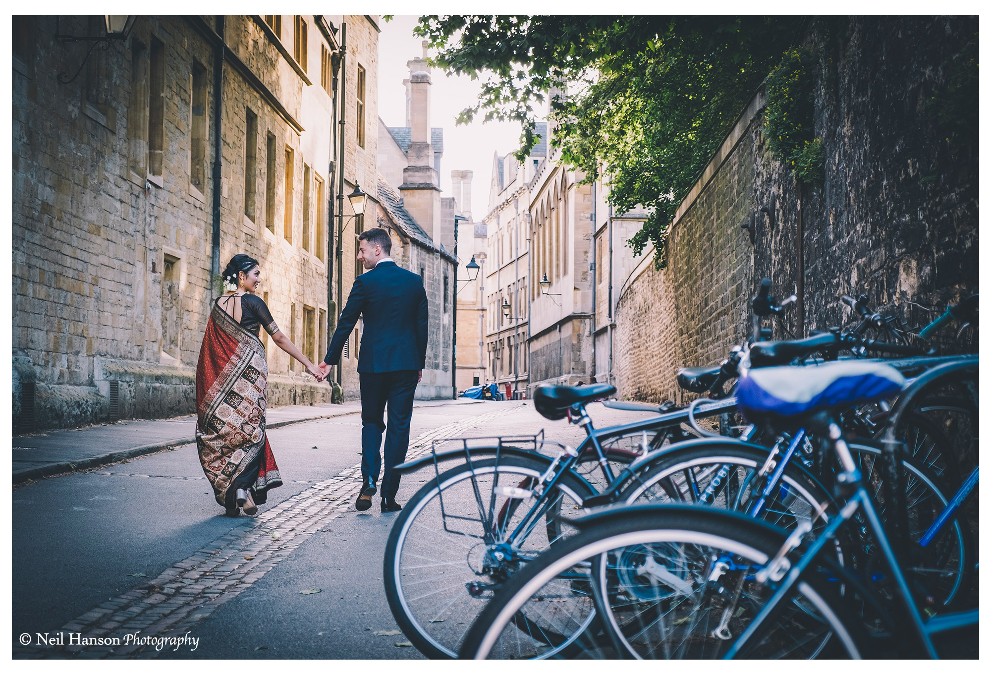 Bride & groom enjoying a walk in Oxford before their wedding reception at the Bodleian Library