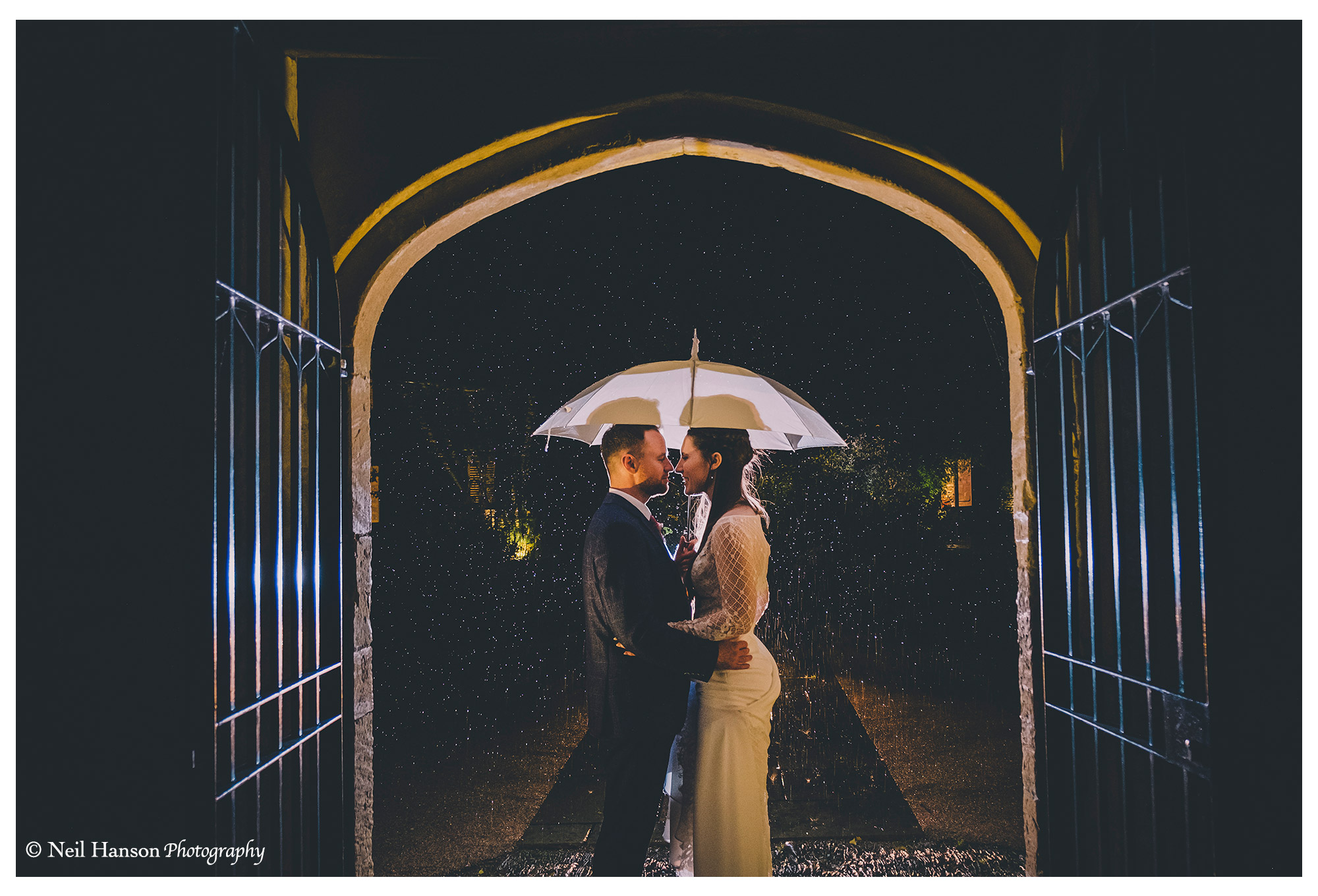 Bride and groom in the rain on their Wedding day at caswell House in Oxfordshire