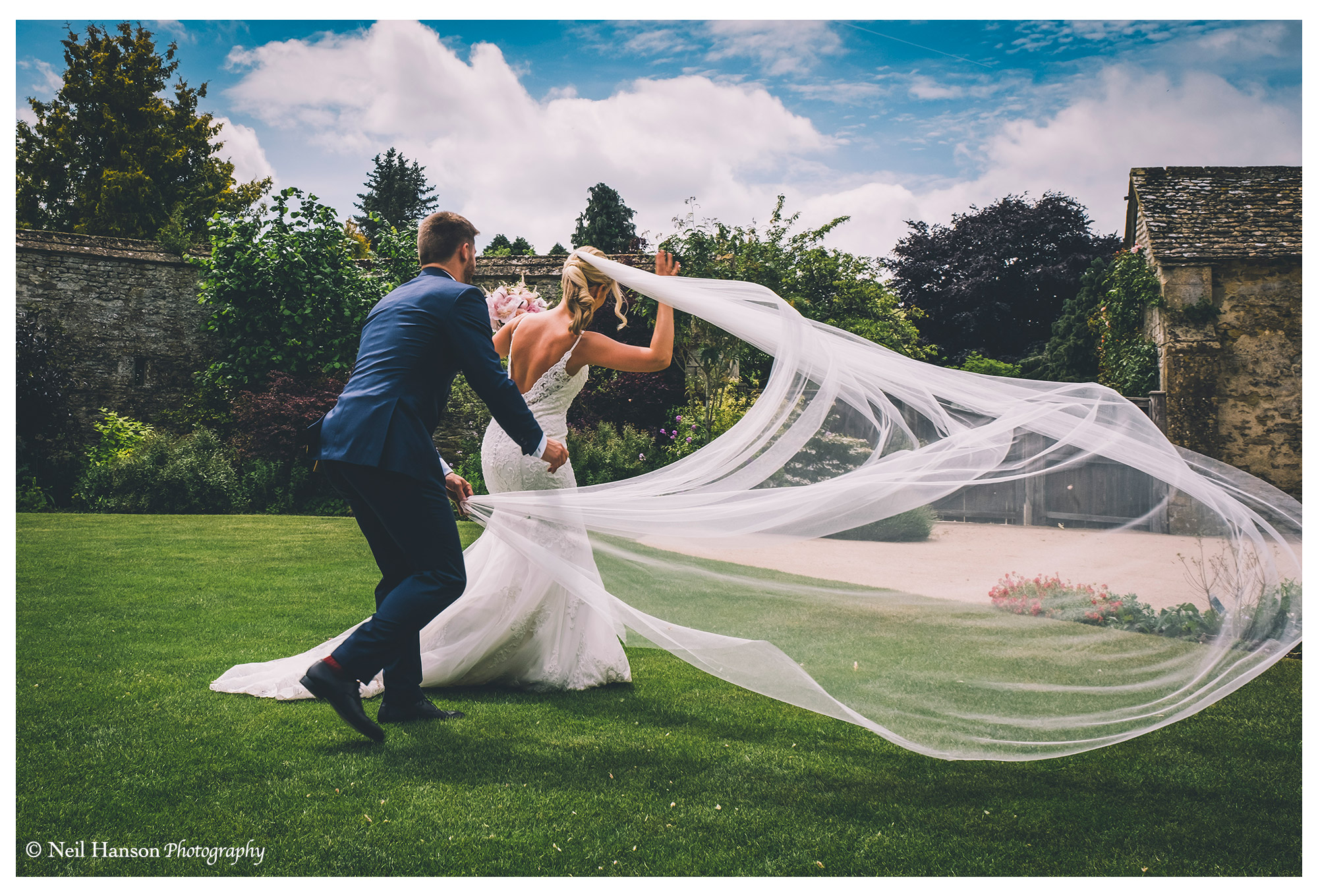 Wind catches the brides veil at her wedding at Caswell House 