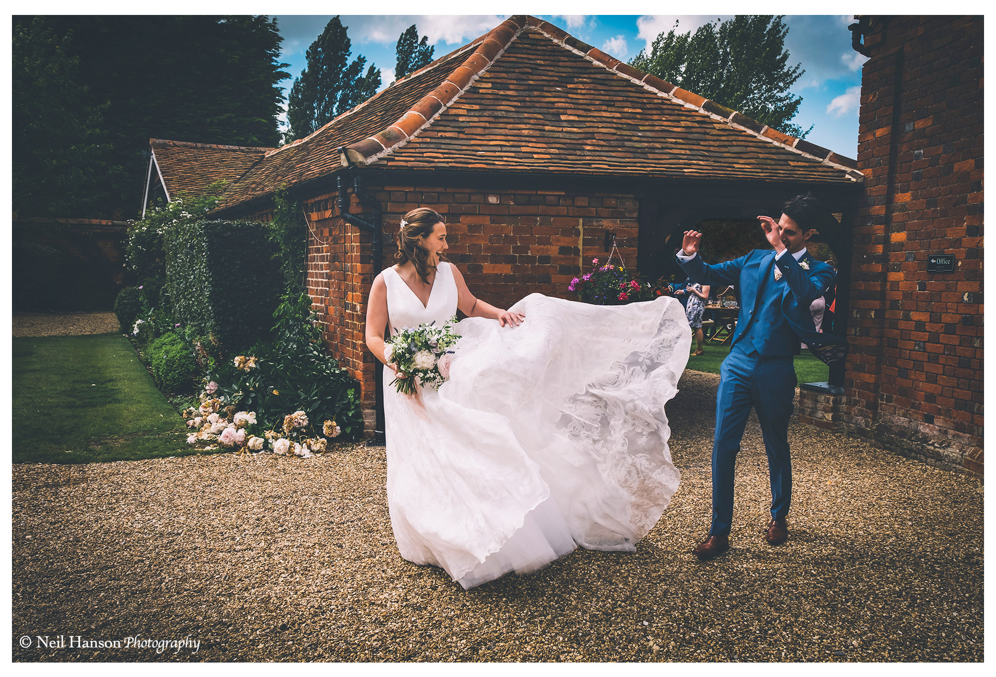 A windy day blows the Brides Wedding dress at Lillibrook Manor Wedding Venue