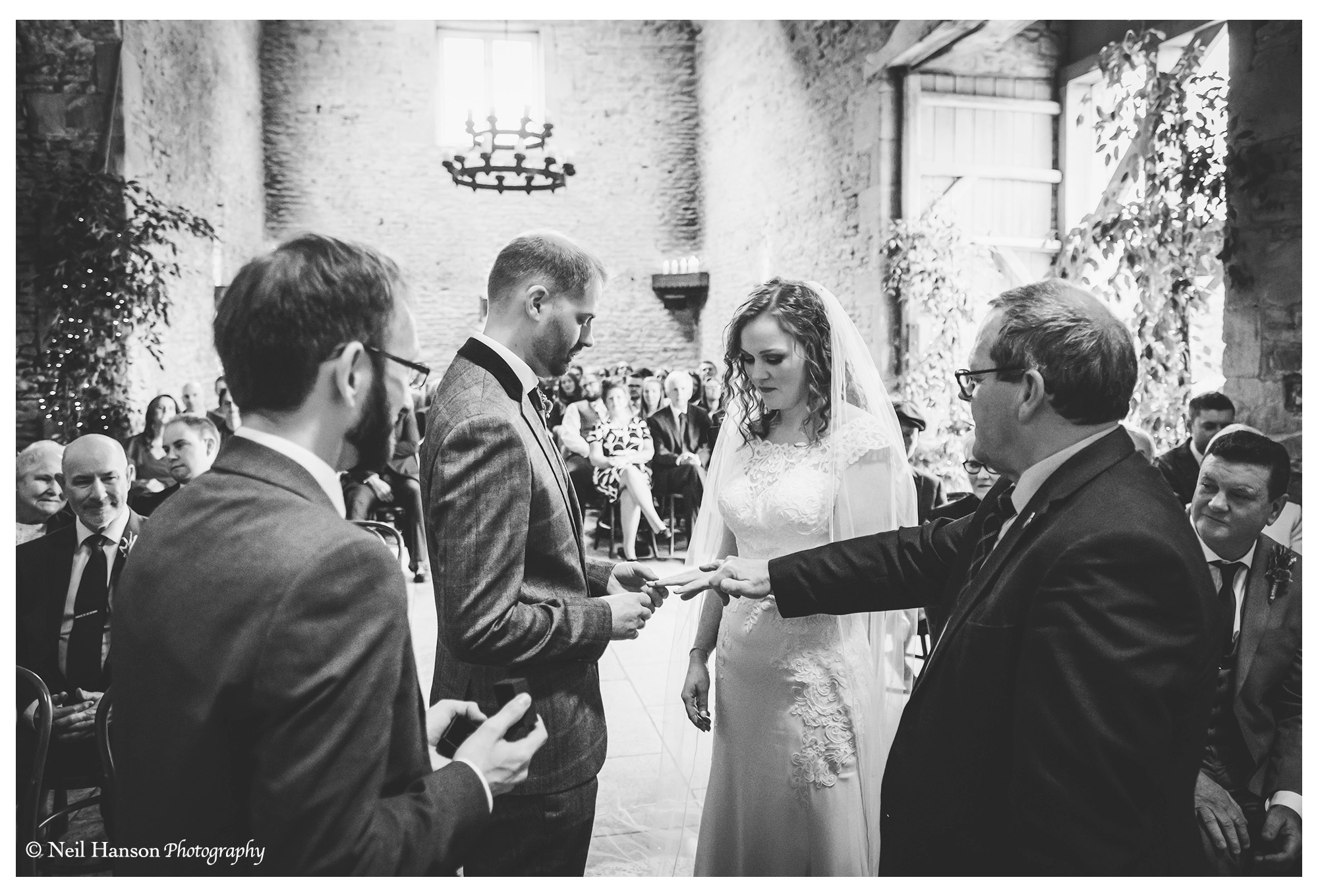 Bride & Groom exchange rings during their wedding ceremony at Cripps Stone Barn