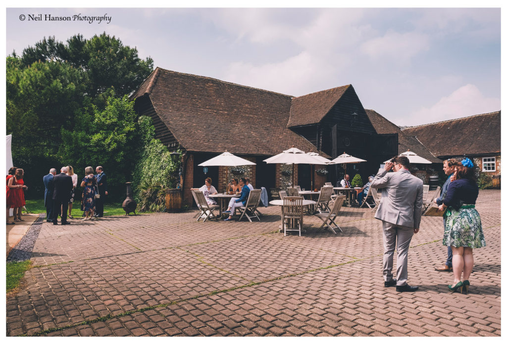 Wedding guests arrive at Old Luxters Barn for a wedding